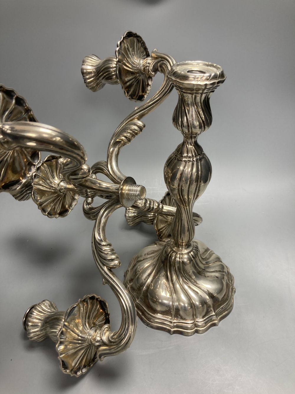 An early 20th century continental 830 white metal four branch, five light candelabrum,